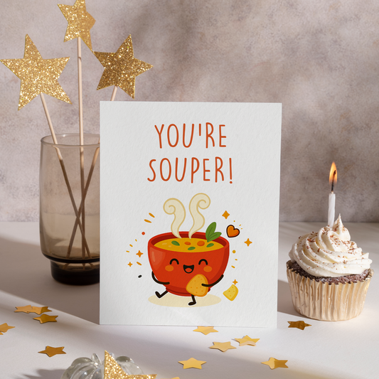 Smiling bowl of soup holding a cracker, surrounded by sparkles and warm colors in a clean illustration style. This adorable card brings comfort and joy, making it a sweet choice for a thoughtful surprise.