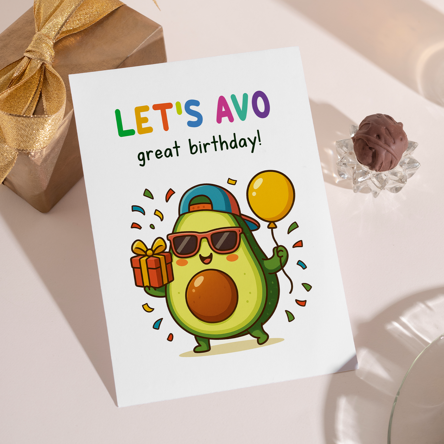 Fun cartoon birthday card featuring an adorable avocado character celebrating with balloons and confetti. The cheerful illustration and clever wordplay create an upbeat and friendly birthday greeting.
