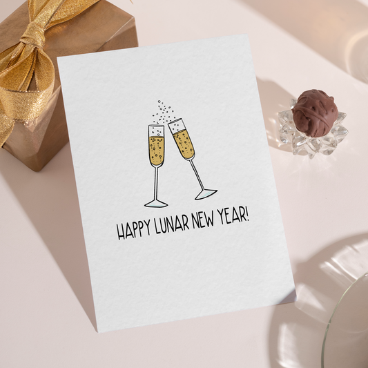 Simple New Year greeting card showing champagne flutes raised in a toast. The design conveys joy, luck, and a festive Lunar New Year celebration.