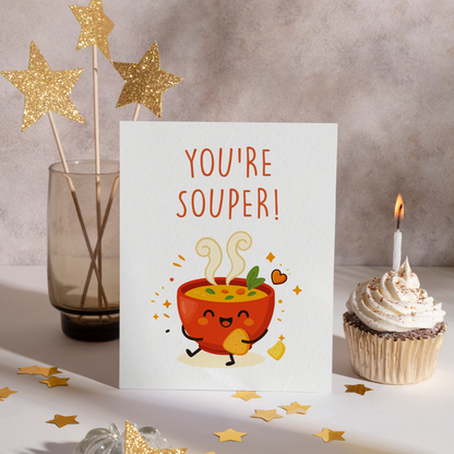 Smiling bowl of soup holding a cracker, surrounded by sparkles and warm colors in a clean illustration style. This adorable card brings comfort and joy, making it a sweet choice for a thoughtful surprise.