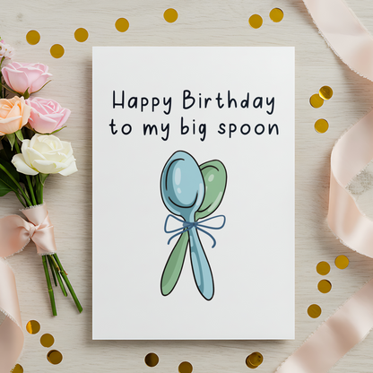 Sweet couple birthday card showing two spoons standing together with a bow in the center. The illustration style is soft and playful, ideal for romantic and cozy birthday celebrations.