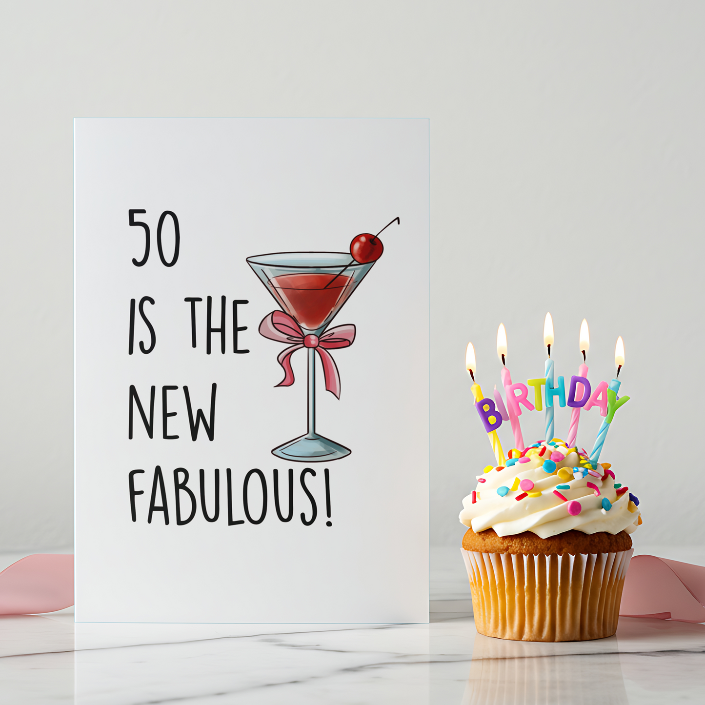 Funny 50th birthday card featuring a martini glass with a cherry and pink bow on a white background. The design celebrates turning fifty with confidence and style.