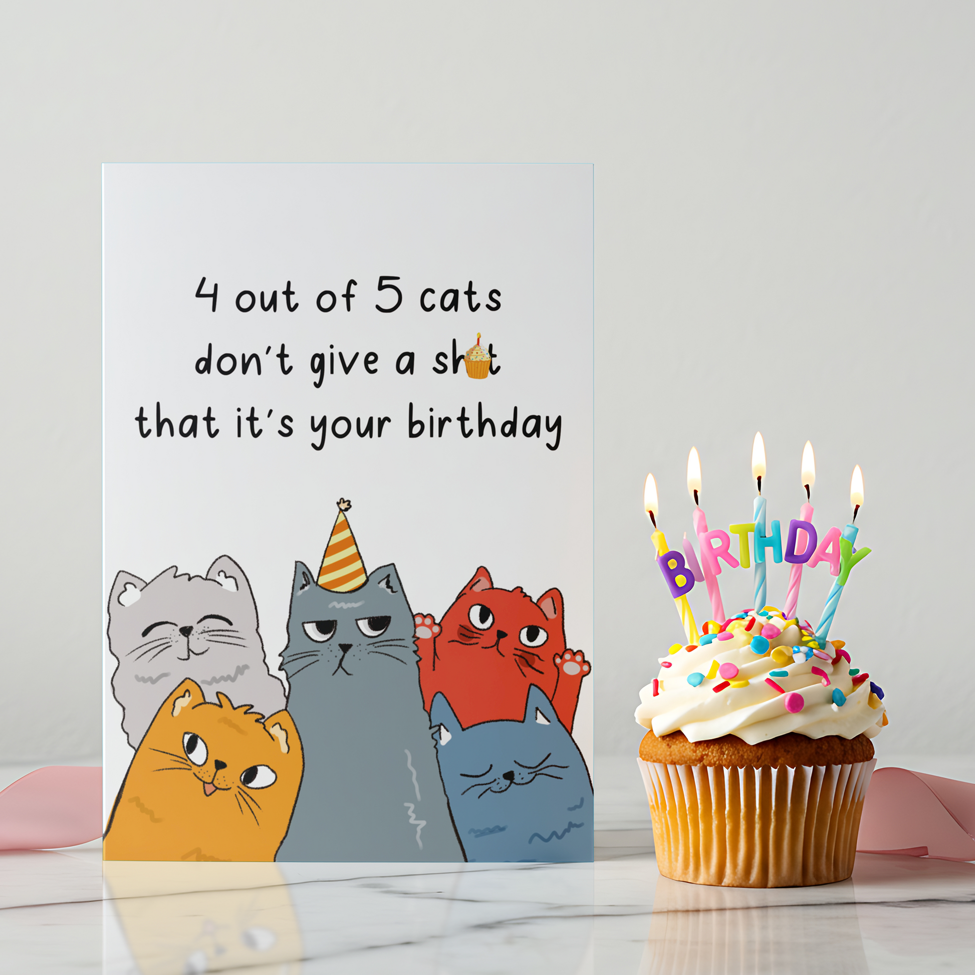Funny birthday card featuring five illustrated cats with unimpressed expressions on a white background. The design uses sarcastic humor to poke fun at birthdays in a playful way.