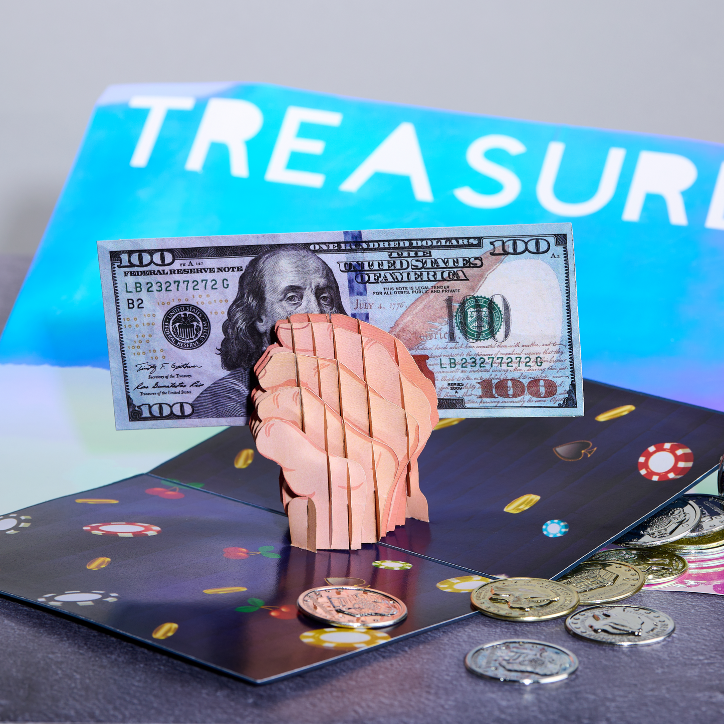 A 3D pop-up card with a clenched fist holding a $100 bill, surrounded by poker chips and coins on a casino-themed background. The word TREASURE is partially visible in the background.