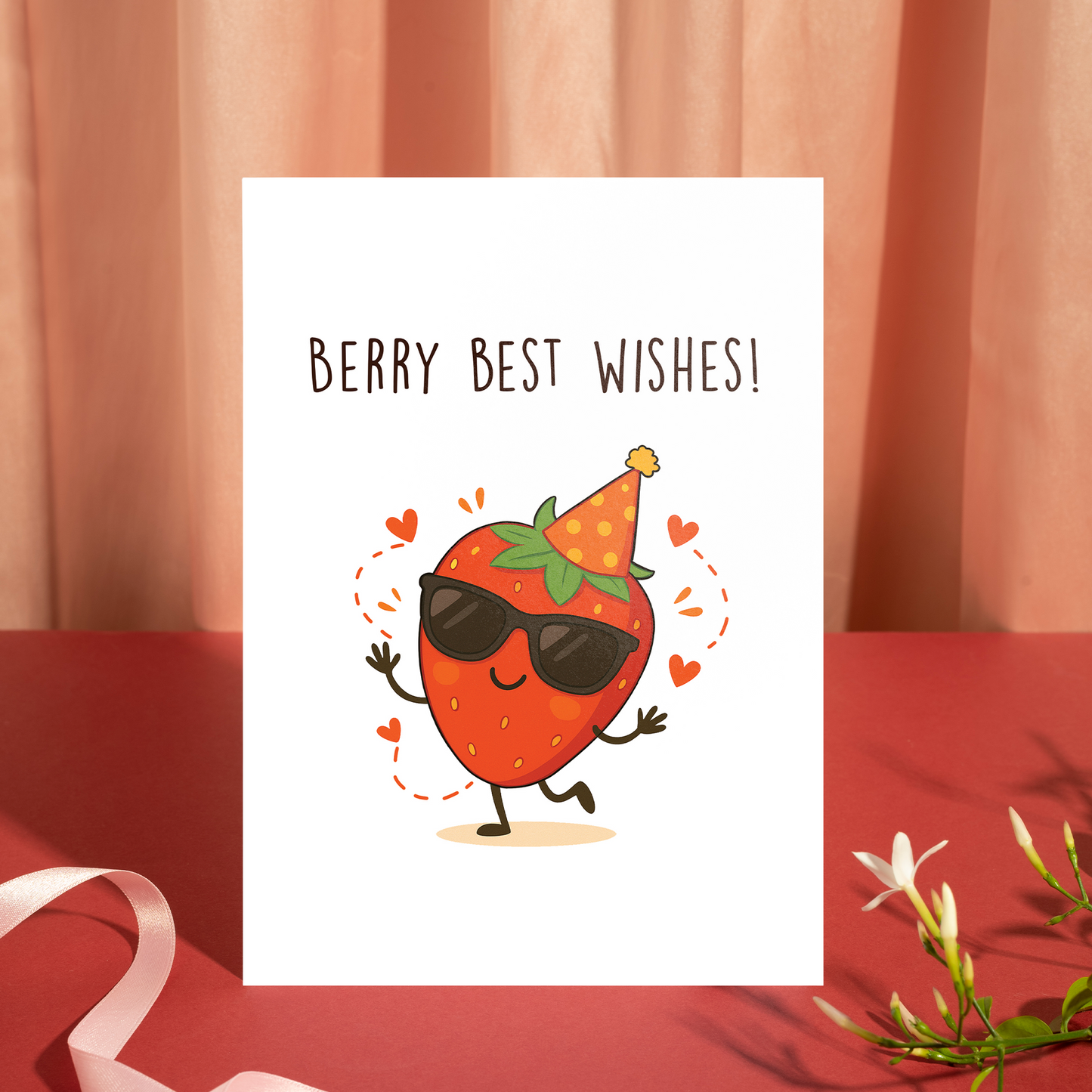 un illustrated card with a cool strawberry in sunglasses and a party hat surrounded by hearts. The “Berry Best Wishes!” text adds a lighthearted and friendly tone.