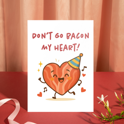 Funny illustrated greeting card with a happy bacon-shaped heart celebrating with a party hat. The lighthearted pun adds charm and humor to the message of love.