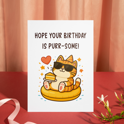 Whimsical birthday card featuring a smiling cat character in sunglasses holding a dessert plate. The design combines cozy colors, hearts, and sparkles to express a fun and purr-some celebration.