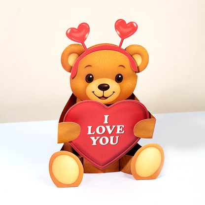 Teddy bear holding a heart with 'I LOVE YOU' text on a white background