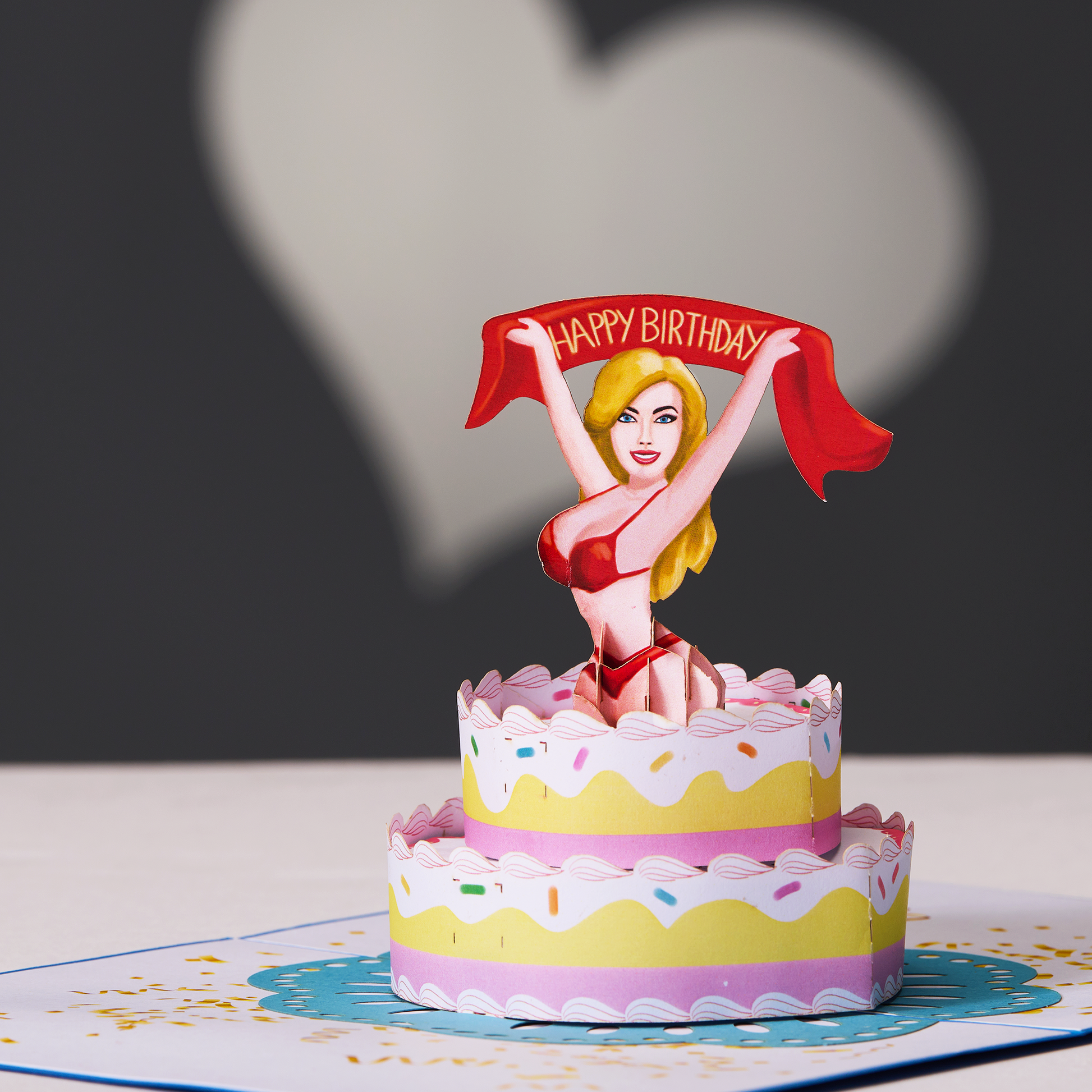 A stunning woman on a cake in a pop-up card, adding elegance and charm to the celebration.