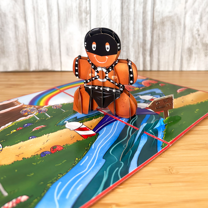 funny christmas card of a pop up gingerbread man wearing latex for the holidays