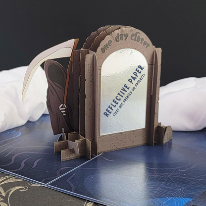 Humorous birthday card featuring Grimp Reaper and a tombstone with a scythe. Engraved text: One day closer.