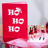 Three lovely ladies dressed as Ms. Santa don playful hats for a hilarious holiday card.