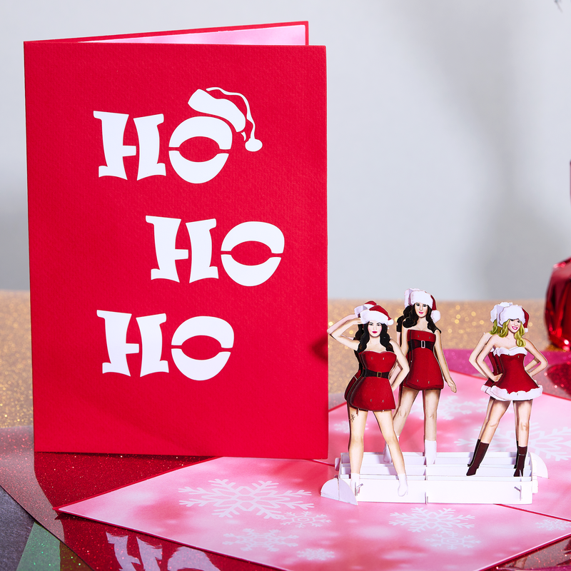 Three lovely ladies dressed as Ms. Santa don playful hats for a hilarious holiday card.