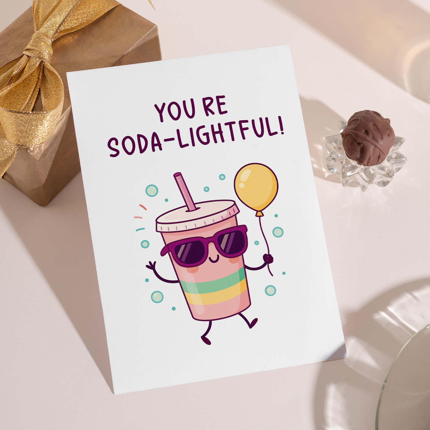 Fun birthday greeting card displaying a cartoon soda drink wearing sunglasses with bubbles all around. The playful soda theme and friendly character make it perfect for a cheerful birthday celebration.