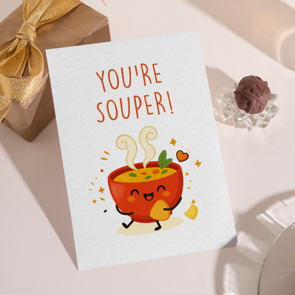 Playful soup illustration with a cute face, heart details, and cozy elements on a white background. The design feels comforting and happy, perfect for telling her she’s simply amazing.