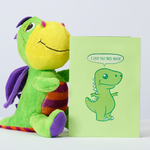 A lovable stuffed dinosaur holding a card that says "I love you this much", with T-rex arms wide open. So sweet and heartwarming!