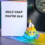 A hilarious pop-up birthday card featuring a rainbow poop emoji. Guaranteed to bring a smile!