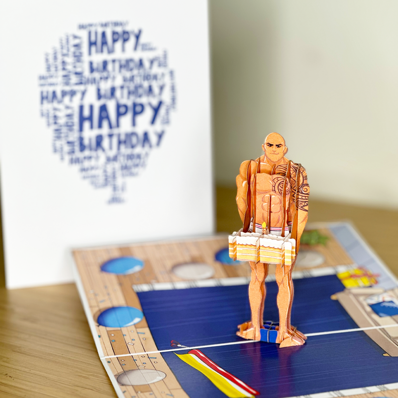 A funny pop-up birthday card showing a handsome man in his bedroom, holding a cake and wishing you a sweet birthday.