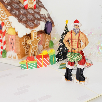 A handsome Santa, carrying two large Christmas ornaments, poses next to a beautifully decorated tree. Merry Christmas!