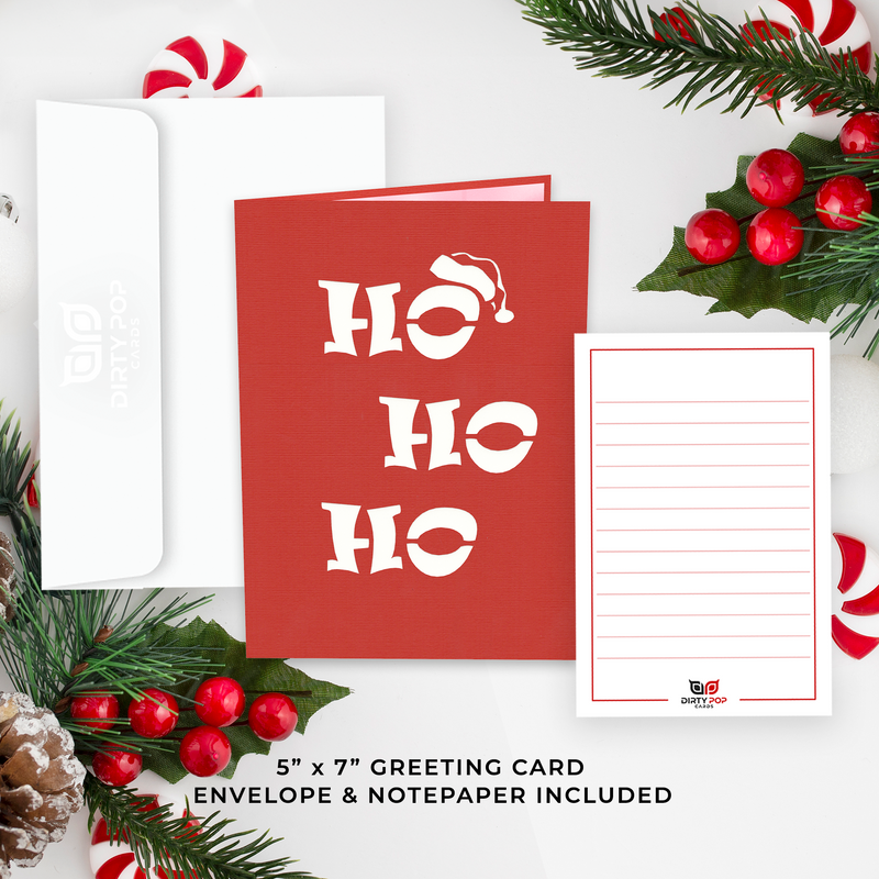 A festive red card with the words "ho ho ho" written on it, creating a joyful and Christmas-y ambiance.