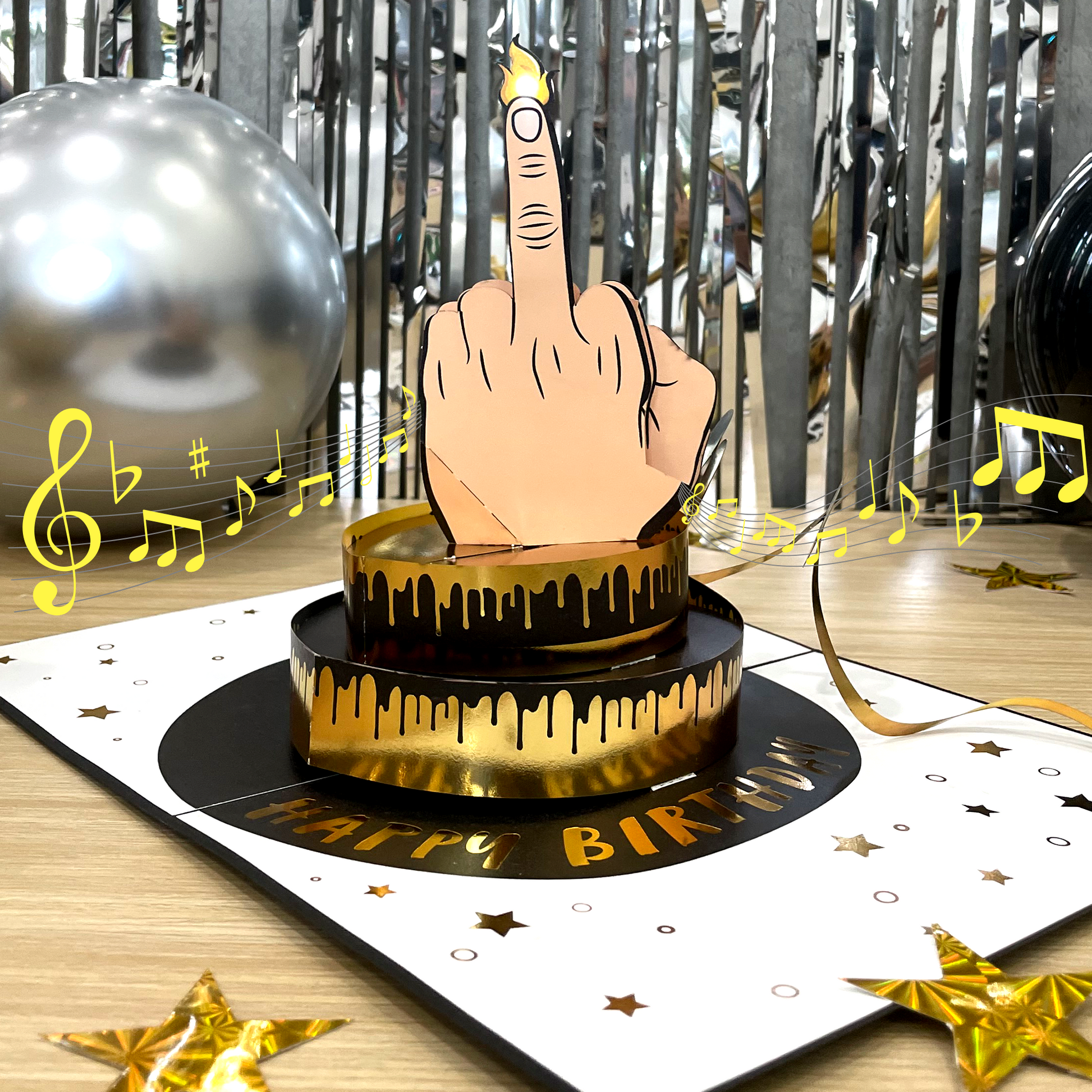 Birthday card with a hand holding a candle on a cake, surrounded by musical notes and decorations.
