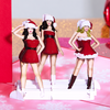 Three beautiful women in festive Santa hats pose together for a funny Christmas card.