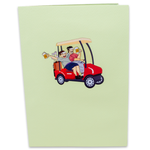 A funny pop-up celebration card with two men laughing while driving a golf cart.