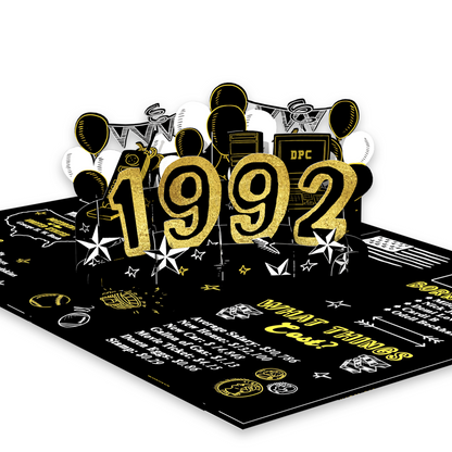 A 3D pop-up card featuring the year '1992' in glittery gold numbers, surrounded by balloons, stars, and retro-themed illustrations on a black background with facts and graphics from 1992