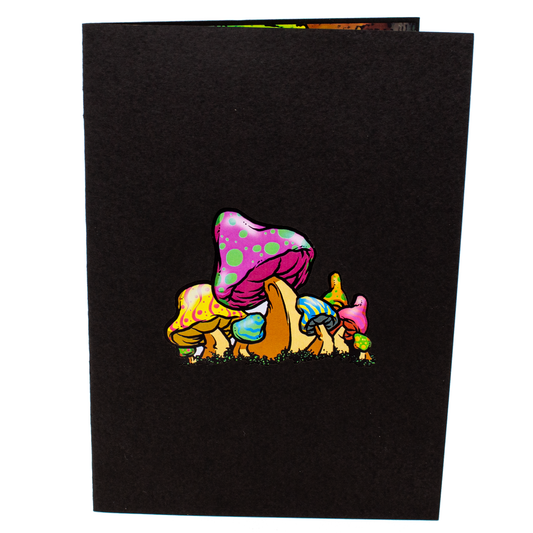 A black card cover featuring a cluster of colorful, psychedelic mushrooms with bright polka dots and stripes in pink, yellow, green, and blue hues, creating a vibrant and eye-catching design.