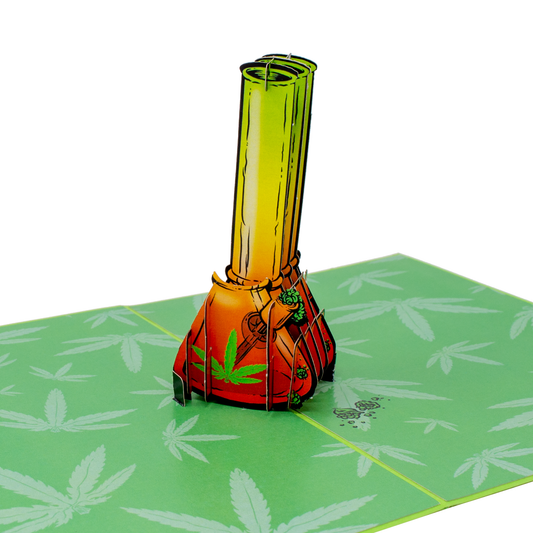 A pop-up card featuring a 3D design of a colorful bong in orange and green tones, adorned with a cannabis leaf. The base is set against a green background with multiple cannabis leaf patterns, creating a playful theme.