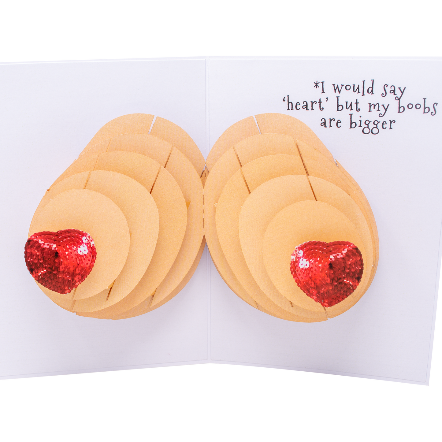 Inside of a humorous pop-up greeting card showing a 3D pair of breasts with red sequin hearts as nipples. The message *I would say heart but my boobs are bigger is written on the right side